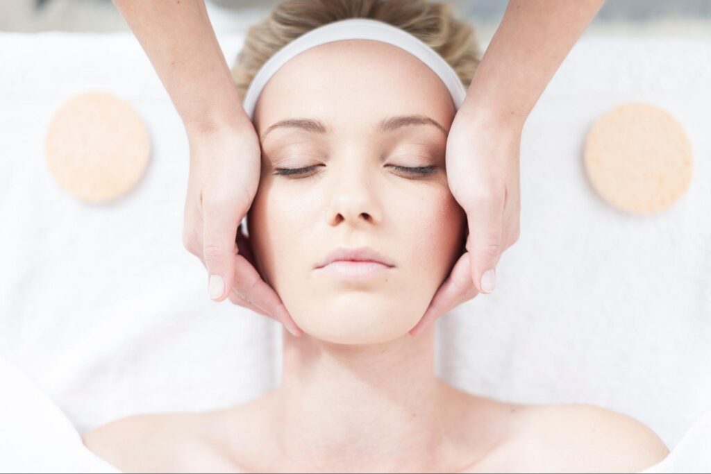 Close-up of a woman receiving a professional facial treatment for acne-prone skin.
