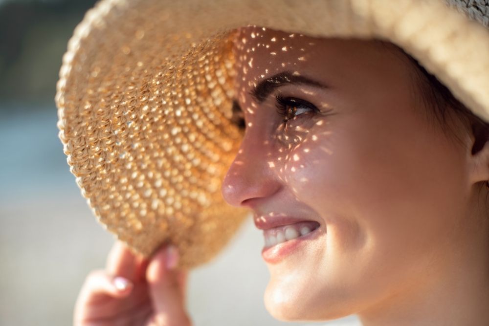 A woman enjoying summer sun with her results from a lash lift and brow lamination.