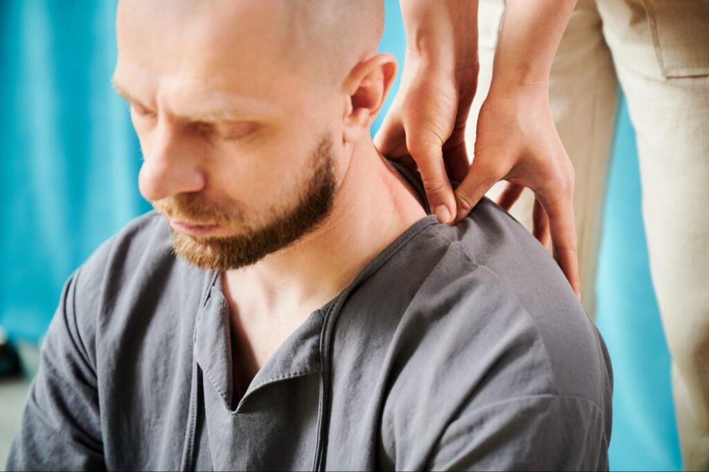 Male client receiving targeted neck and shoulder treatment.